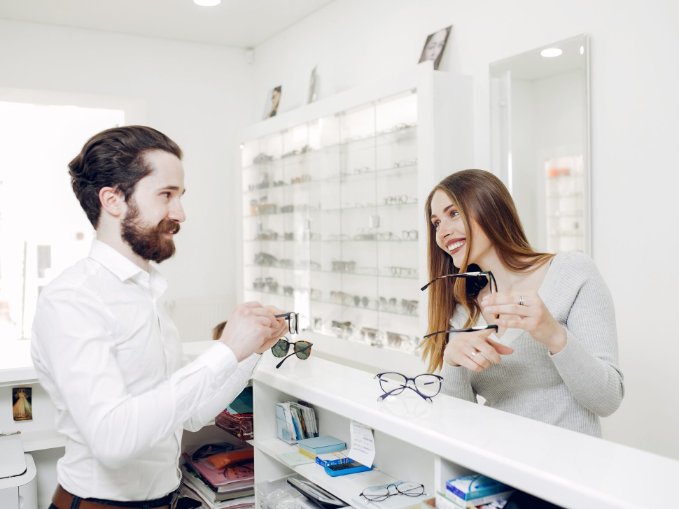 Mother with cute son. Family buy glasses. Assistant helping the clients